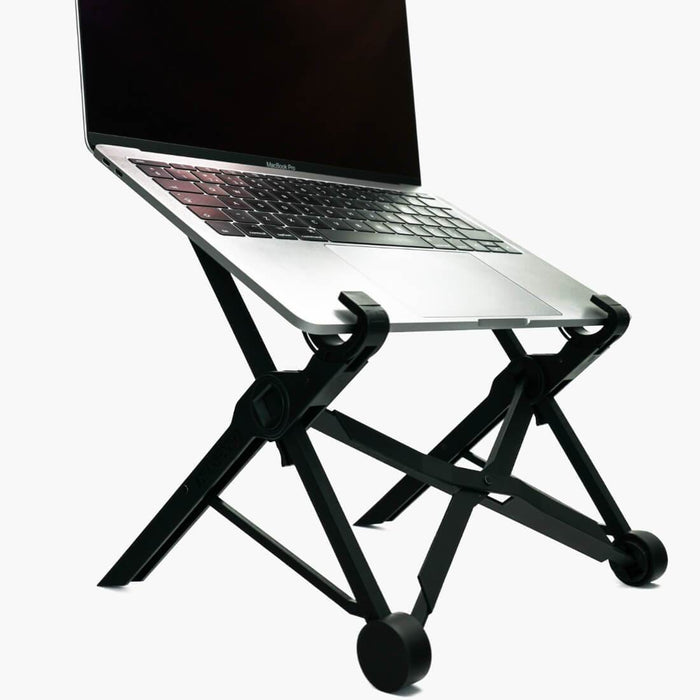 Black NEXSTAND K2 Portable and height adjustable laptop stand with silver macbook pro on top